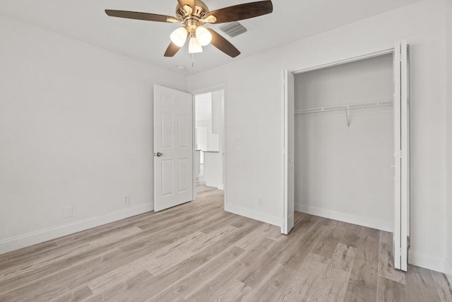 unfurnished bedroom featuring ceiling fan, a closet, and light hardwood / wood-style flooring