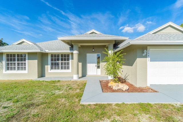 view of front of home with a garage and a front lawn