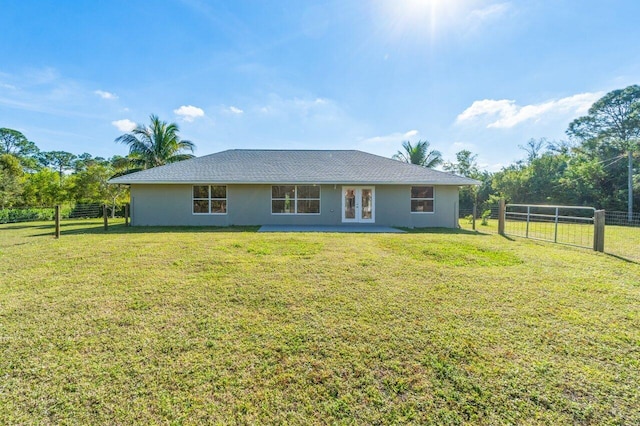 back of house with a yard and french doors