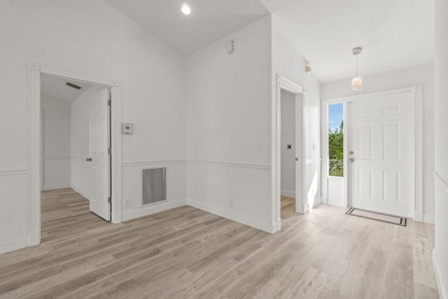 foyer featuring vaulted ceiling and light wood-type flooring