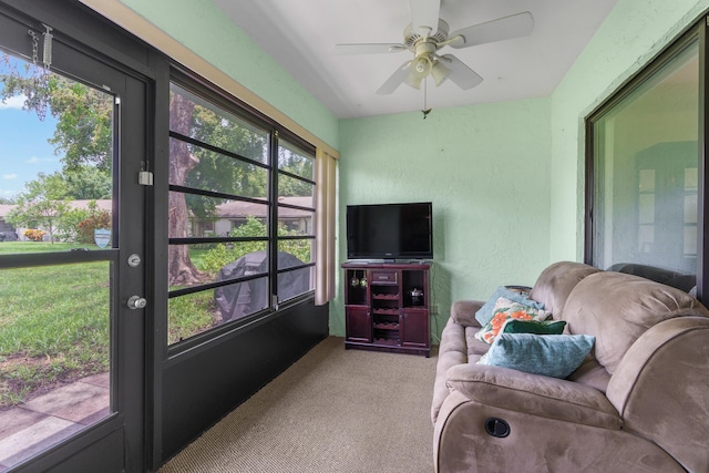 sunroom / solarium featuring ceiling fan