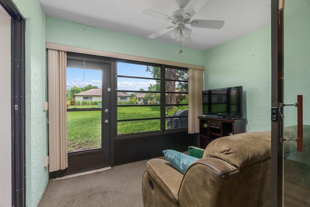 interior space featuring ceiling fan, carpet floors, and a healthy amount of sunlight