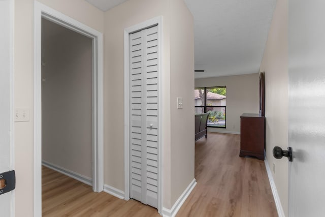 hall featuring a textured ceiling and light wood-type flooring