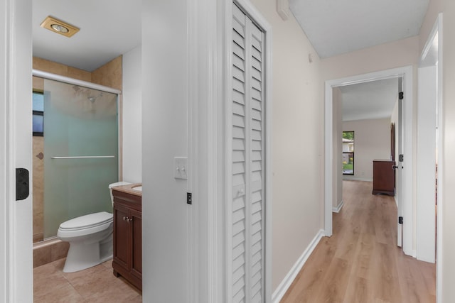 bathroom with a shower with door, vanity, hardwood / wood-style flooring, and toilet