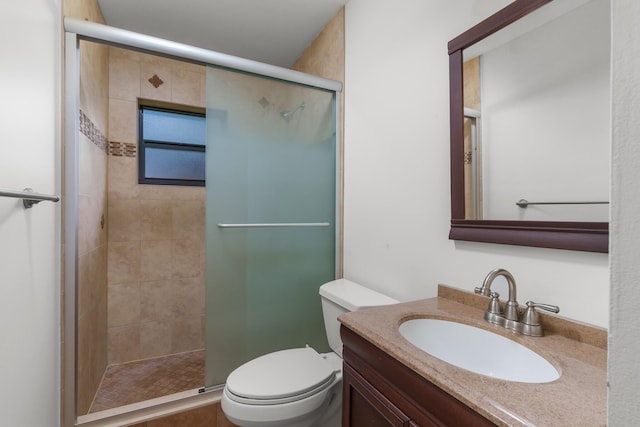 bathroom with walk in shower, vanity, and toilet