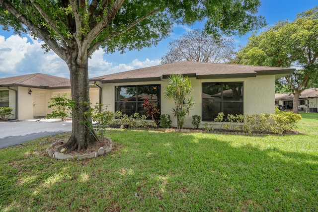 ranch-style home with a front lawn