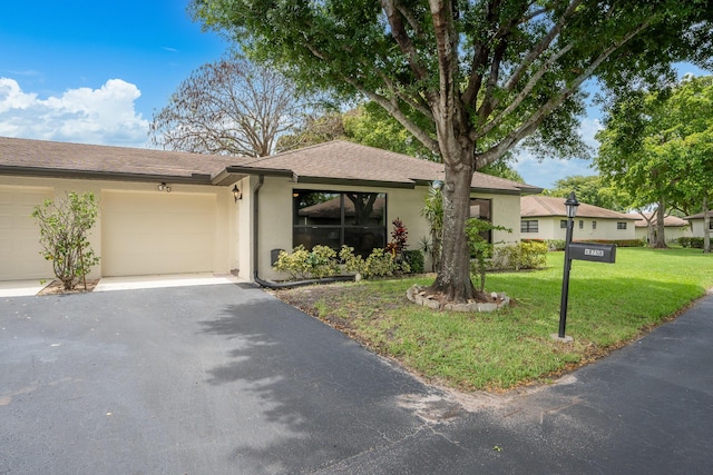 view of front of home featuring a garage and a front yard