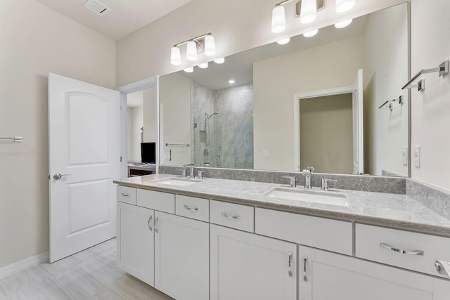 bathroom featuring vanity and a shower with shower door