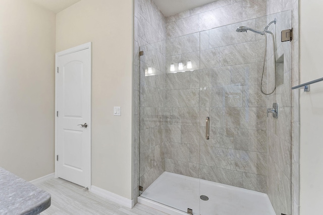 bathroom with a shower with shower door