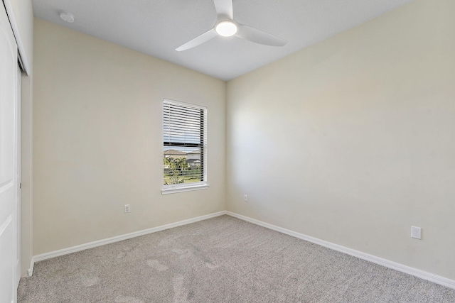 unfurnished room with light colored carpet and ceiling fan