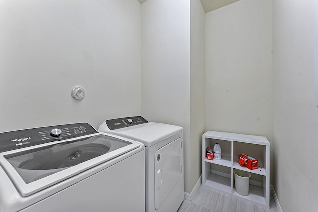 clothes washing area featuring washer and clothes dryer