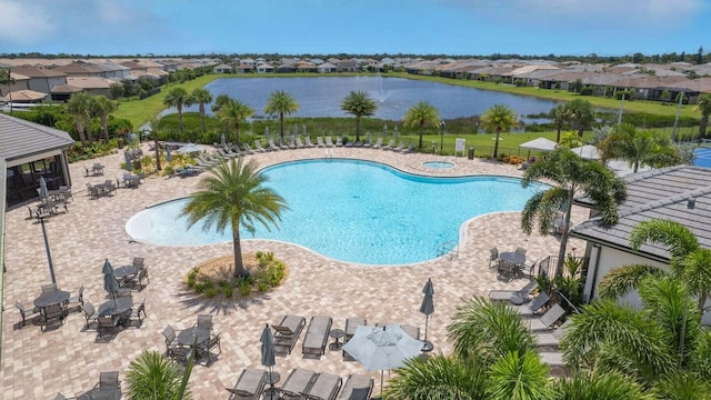 view of pool featuring a patio and a water view