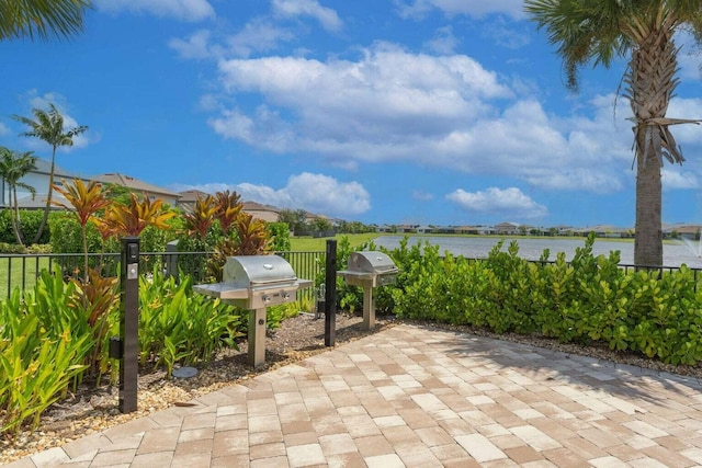 view of patio / terrace with a water view and grilling area