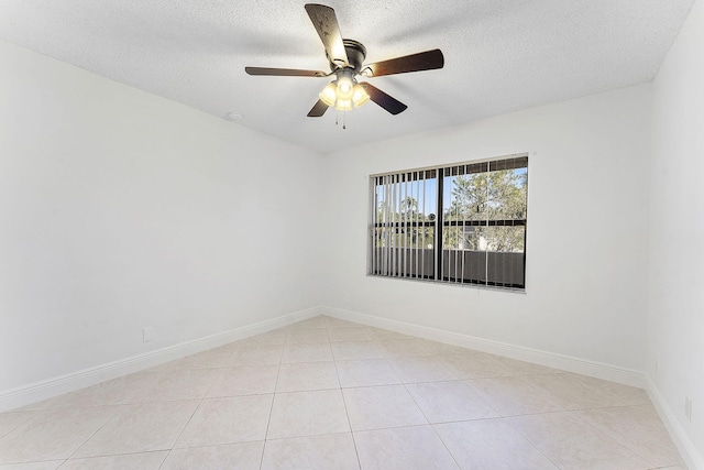 unfurnished room featuring light tile patterned flooring, ceiling fan, and a textured ceiling