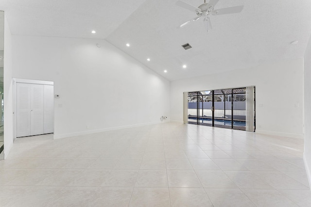 tiled empty room featuring high vaulted ceiling and ceiling fan