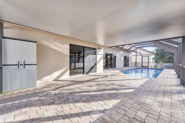 view of pool with a lanai and a patio