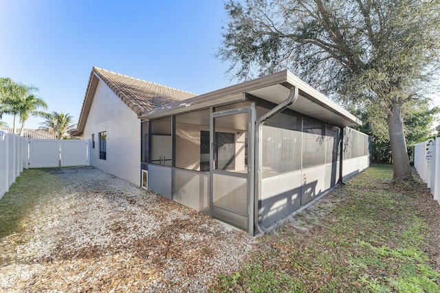 back of property featuring a sunroom