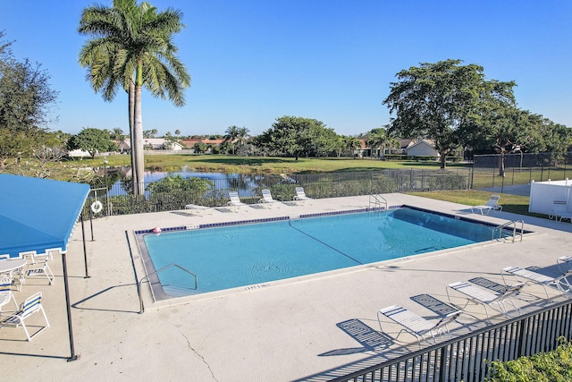 view of pool featuring a water view and a patio area