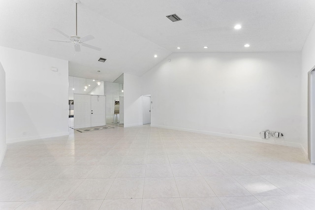 tiled empty room with high vaulted ceiling and ceiling fan