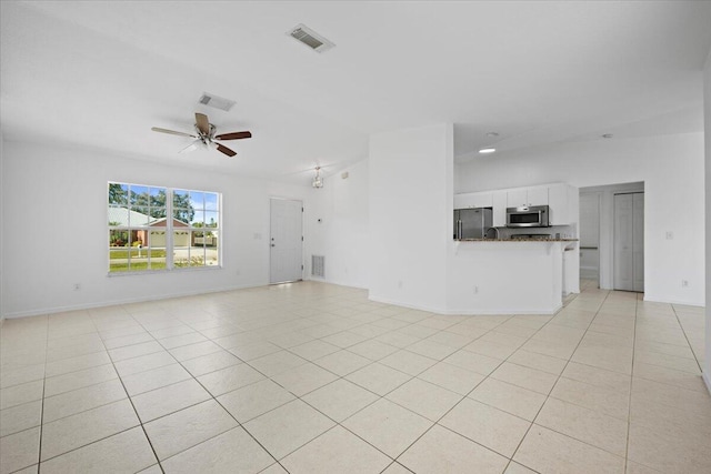 unfurnished living room featuring ceiling fan and light tile patterned flooring