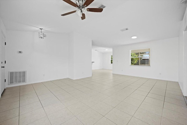 tiled empty room featuring ceiling fan