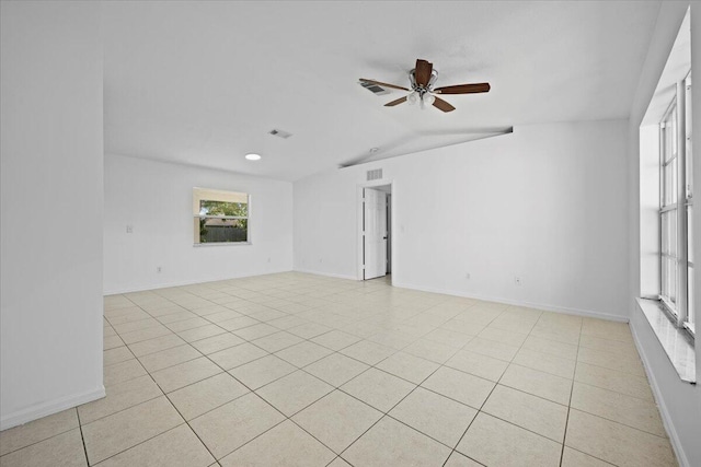 unfurnished room with lofted ceiling, light tile patterned floors, and ceiling fan