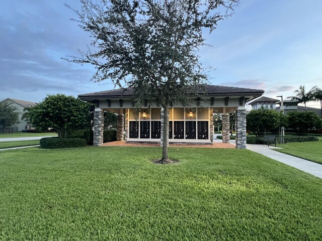 4582 San Fratello Cir, Lake Worth, FL 33467 - back of house with a yard, stone siding, and stucco siding