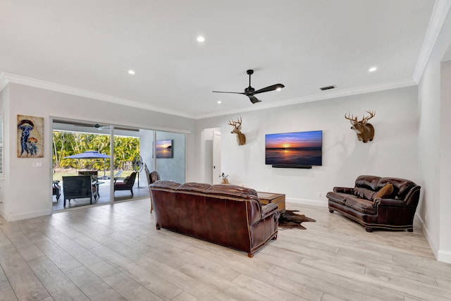 living room featuring crown molding, ceiling fan, and light wood-type flooring