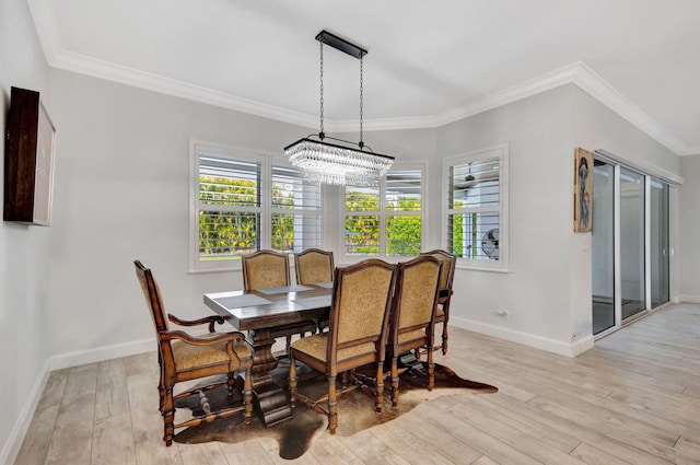 dining room featuring crown molding, a chandelier, and light hardwood / wood-style floors