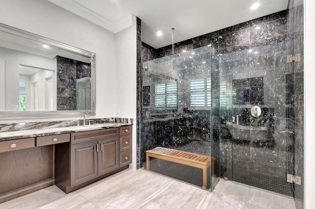 bathroom featuring an enclosed shower and vanity