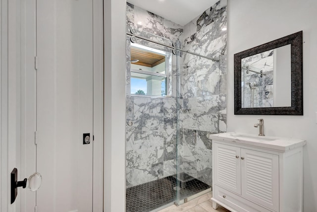 bathroom with vanity and a shower with door