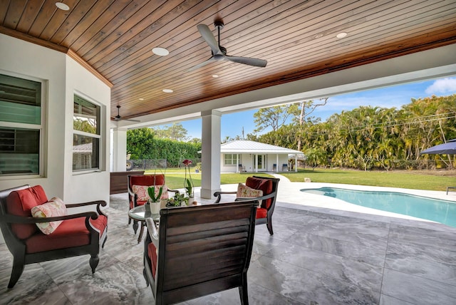 view of patio / terrace featuring an outdoor hangout area, an outbuilding, and ceiling fan