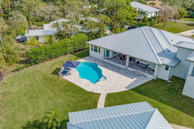 view of swimming pool with a patio area and a lawn