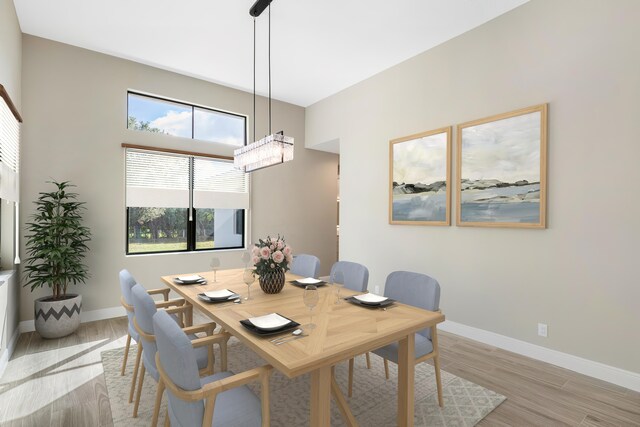 living room with ceiling fan, a raised ceiling, hardwood / wood-style floors, and a wealth of natural light