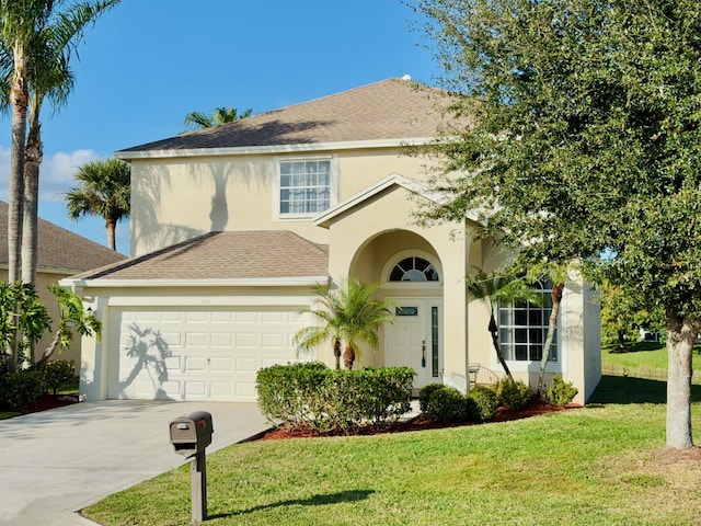 view of front of house with a front lawn and a garage