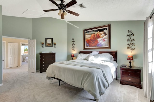 bedroom with vaulted ceiling, ceiling fan, and light colored carpet