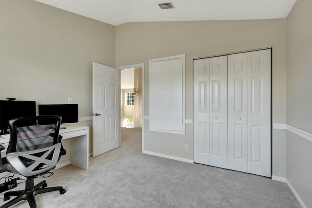 office area with vaulted ceiling and light carpet