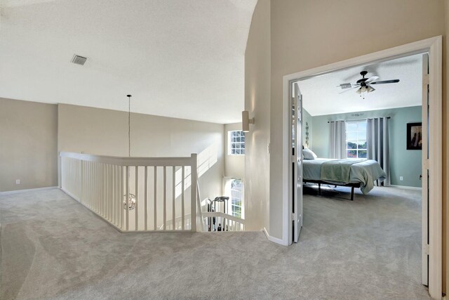 bedroom with lofted ceiling, light carpet, and ceiling fan