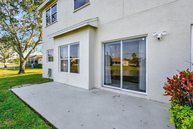 exterior space with a patio area and a lawn