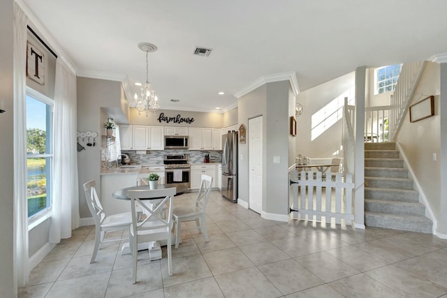 dining area with ornamental molding, sink, an inviting chandelier, and light tile patterned floors