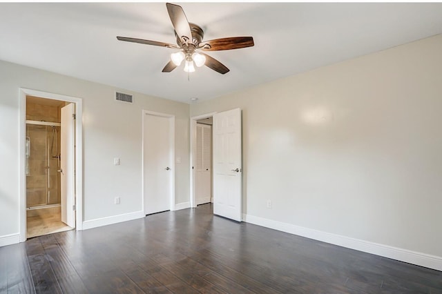 unfurnished bedroom with ceiling fan, dark hardwood / wood-style flooring, and ensuite bath