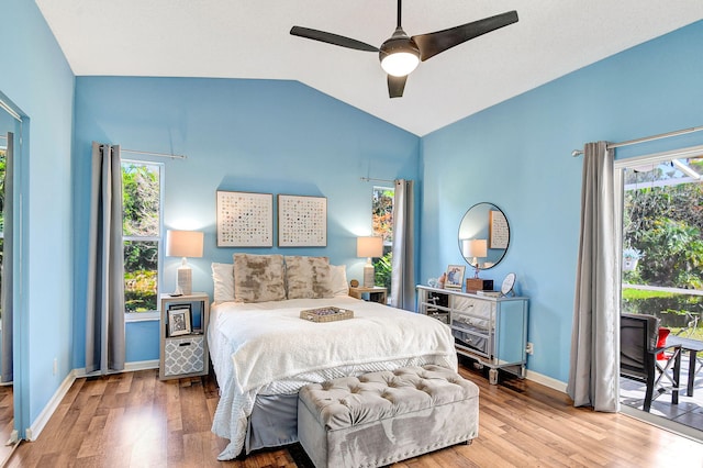 bedroom featuring ceiling fan, wood-type flooring, vaulted ceiling, and access to outside