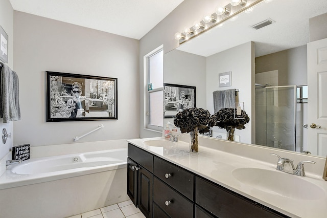 bathroom featuring vanity, tile patterned flooring, and separate shower and tub