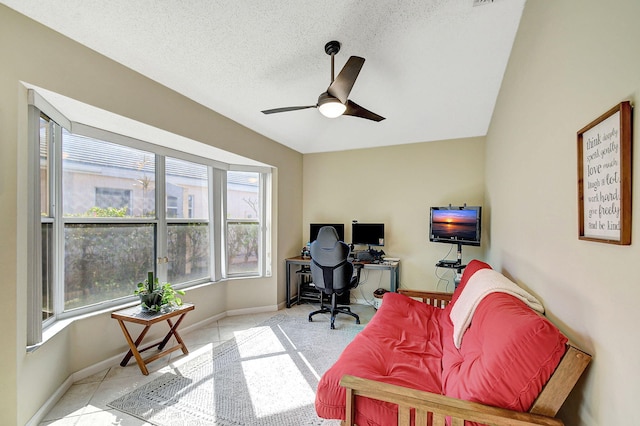 tiled home office with ceiling fan and a textured ceiling