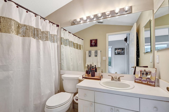 bathroom featuring a shower with curtain, vanity, lofted ceiling, and toilet