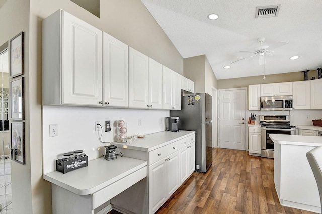 kitchen with white cabinets, ceiling fan, stainless steel appliances, dark wood-type flooring, and a textured ceiling