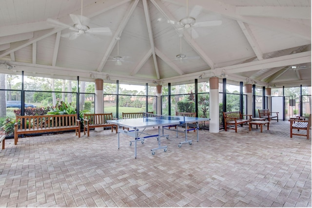 sunroom / solarium with beamed ceiling and ceiling fan