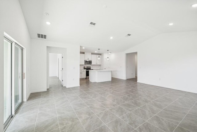 unfurnished living room featuring recessed lighting, visible vents, and lofted ceiling