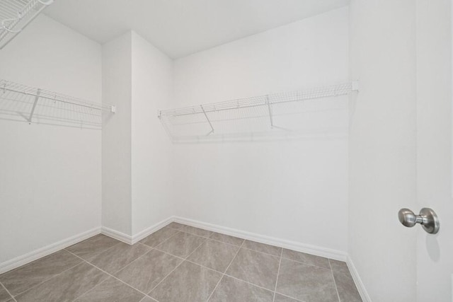 spacious closet with tile patterned floors