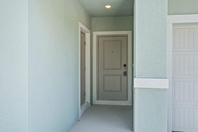 view of exterior entry with stucco siding